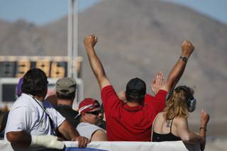 A fan cheers a quarterfinal run during the NHRA Las Vegas Nationals at the Las Vegas Motor Speedway Sunday, Nov. 1, 2009. 