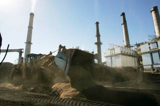 A payloader mixes wood chips with coal at NV Energy's Reid Gardner Station coal-fired power plant Wednesday, Nov. 4, 2009 near Moapa.  