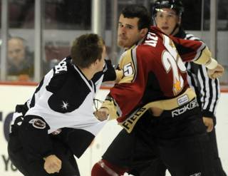 Kyle Hagel, left, faces off against Eric Lizon during the first period of play between Las Vegas and Bakersfield on Thursday night.