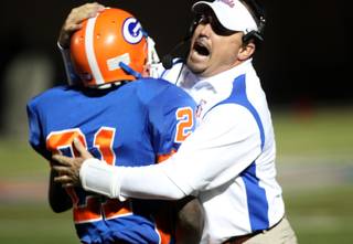 Bishop Gorman coach Tony Sanchez hugs Johnathan Loyd after Loyd ran back a punt for a touchdown Friday in the Sunset Regional quarterfinals against the Cheyenne Desert Shields. Gorman dominated with a 56-15 victory.