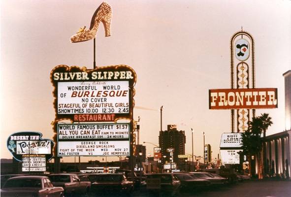 In this 1968 photo,  the marquees of three Howard Hughes hotels light up at dusk. Rumors flew at the time that Hughes bought the Silver Slipper casino because he feared a camera was placed inside the toe of the shoe, which always stopped and faced his Desert Inn penthouse. After the casino's previous owners refused his repeated requests to turn off the shoe, Hughes bought it in 1968.