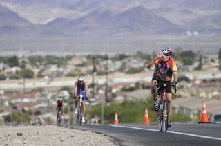 Richard McKeown of Henderson takes a drink of water after reaching the top of a hill on Horizon Ridge Parkway while participating in the fifth annual Ironman 70.3 Silverman triathlon in Henderson in 2009.