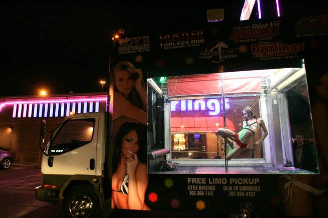 "Kay," a dancer from Deja Vu Showgirls, practices her moves inside a truck to advertise the club on the Las Vegas Strip late in the evening Monday, Nov. 9, 2009. 