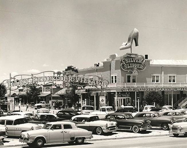 Cars park outside the Silver Slipper Gambling Hall in this photo taken in the late 1950s to early '60s. Its original name is the Golden Slipper Gambling Hall and Saloon because "Silver Slipper" is unavailable at the time. It sits on the Last Frontier Village, right next to the Frontier Hotel. 