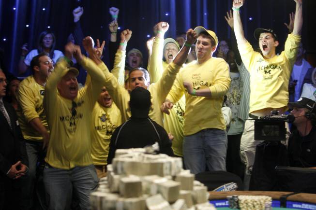 Friends and family react as Joe Cada, bottom center, a 21-year-old poker professional from Michigan, wins the World Series of Poker tournament at the Rio on Tuesday, Nov. 10, 2009. Cada got past Darvin Moon, a 45-year-old logger from Maryland, to win $8.5 million in prize money. 
