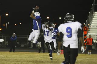 Basic wide receiver Kelly Armistead leaps for a reception over Desert Pines Friday during the Sunrise Region playoff game at Basic. The Wolves were victorious over the Jaguars 24-17.