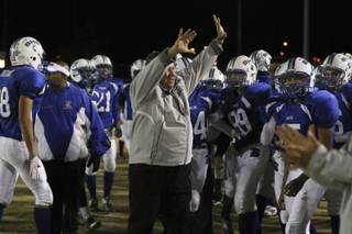 Basic assistant coach Dan Cahill celebrates with his team after a kickoff fumble recovery during the Sunrise Region semifinal game Friday night at Basic.  The Wolves were victorious over the Falcons 42-20.