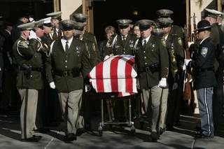 The body of Metro officer Trevor Nettleton is carried out of St. Elizabeth Ann Seton Church after funeral services Wednesday, November 25, 2009.