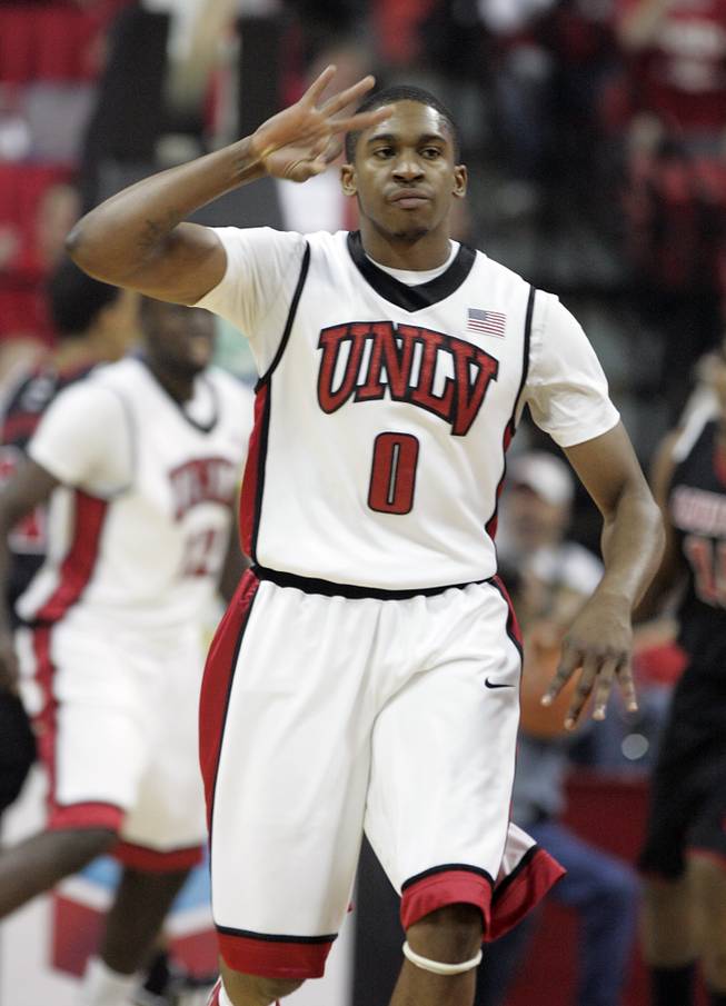 UNLV guard Oscar Bellfield signals sinking a 3-point shot against Louisville during the first half of a game on Nov. 28, 2009, at the Thomas & Mack Center. The Rebels upset the No. 16 Cardinals, 76-71.