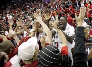 UNLV forward Brice Massamba and the rest of the Rebels celebrate their 76-71 upset of 16th-ranked Louisville Saturday at the Thomas & Mack Center.