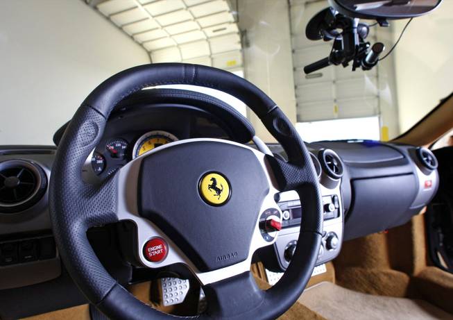 The interior of a 2007 Ferrari F430 F1 is displayed in the Exotics Racing warehouse at the Las Vegas Motor Speedway. Cameras, at top right, can record the road ahead. 