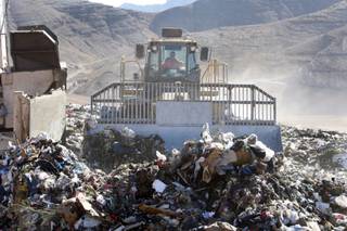 An operator drivers a compacter over garbage at the Apex landfill northeast of Las Vegas Monday, November 23, 2009. 
