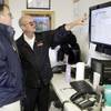 
Road supervisor John Homan, right, explains the TaxiTronic GPS technology to new driver Doug Boyle at Deluxe Taxicab Services in Henderson. 