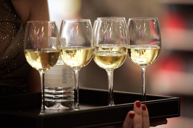 Wine is served to guests during a VIP party to ...
