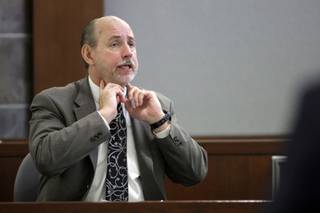 Clark County Chief Medical Examiner Larry Sims of the Clark County Coroner's Office testifies Friday, Dec. 18, 2009, during an inquest into the death of Dustin Boone. Boone died Nov. 4 after Metro Police officers attempted to take him into custody.