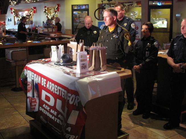 Metro Police Sgt. Richard Strader speaks at the T-Bird Lounge about law enforcement's plans to crack down on drunken driving during the holidays.