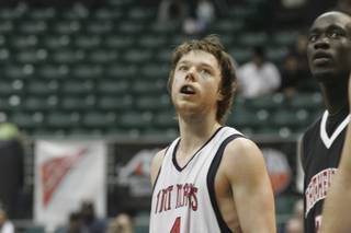 Saint Mary's guard Matthew Dellavedova looks on as a Northeastern player shoots free throws on Tuesday morning at the Diamond Head Classic in Honolulu. Dellavedova scored 17 points, including four 3-pointers, in the Gaels' 78-67 victory at the Stan Sheriff Center.