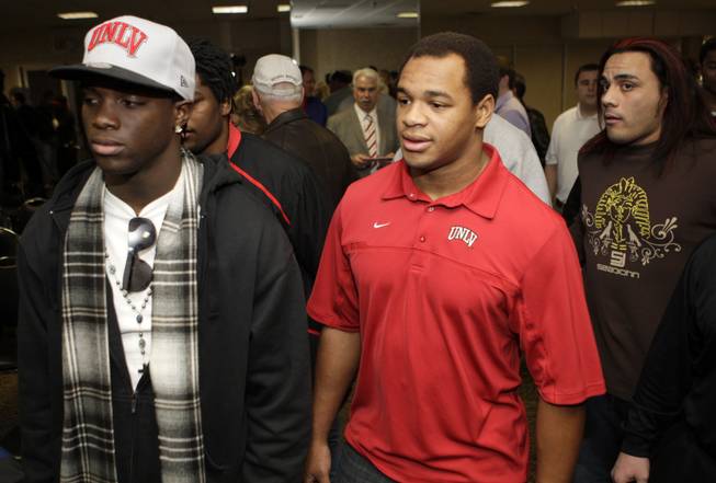 UNLV football players wait to meet new UNLV head football coach Bobby Hauck during a news conference at UNLV Wednesday, December 23, 2009. From left, are Chris Jones, Nathan Carter, and Malo Taumau.