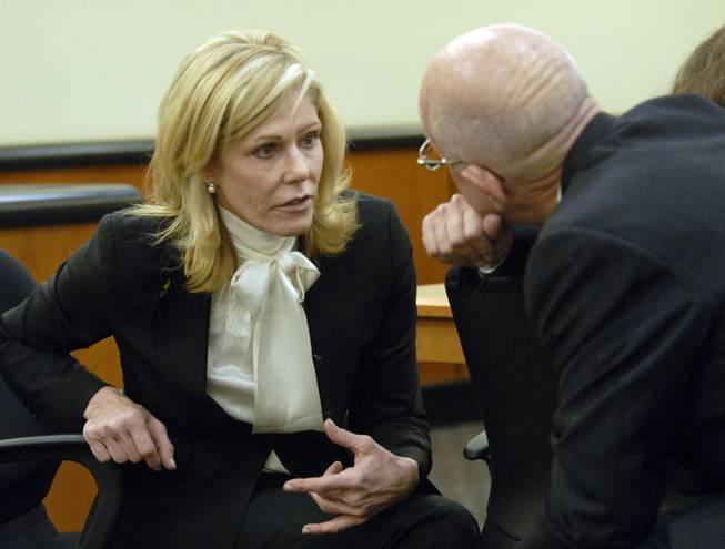 Nevada First Lady Dawn Gibbons confers with her attorney, Cal Dunlap, before a court hearing in Reno on Monday, Dec. 28, 2009, on the settlement of her divorce from Gov. Jim Gibbons. The divorce trial was due to start Monday morning just as the settlement was made.