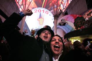 Brian Flynn and Ayme Hosseini of Orange County, Calif., ring in the new year just before the stroke of midnight during New Year's 2010 TributePalooza at the Fremont Street Experience in downtown Las Vegas Thursday, December 31, 2009.