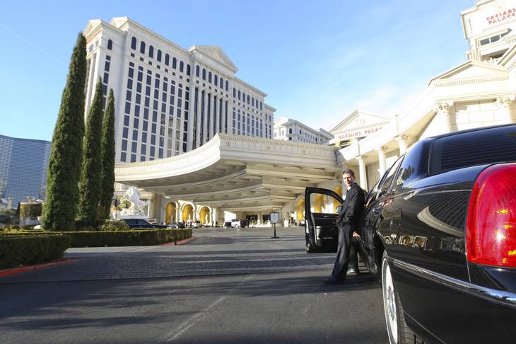 Limousine driver Geroge Liebhardt waits outside Caesars Palace for guests to require his services on New Year's Day morning following the New Year's Eve celebration on the Las Vegas Strip.