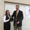 Henderson Mayor Andy Hafen presents homeowner Emma Hurtado with a key to the City of Henderson at a gathering Friday in front of Nevada's first rehabilitated foreclosed home.