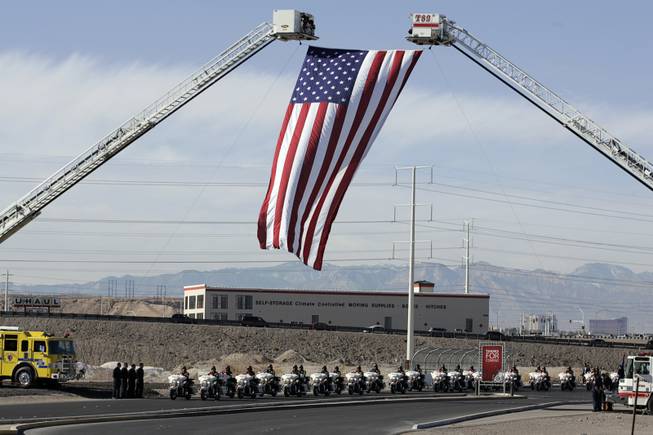 The funeral procession for slain court security officer Stanley Cooper arrives at Central Christian Church in Henderson for a memorial service Monday, January 11, 2010.