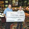 Steve Fezzik, left, receives his $196,800 check from Las Vegas Hilton sports book executive director Jay Kornegay after winning the 2009 Supercontest.