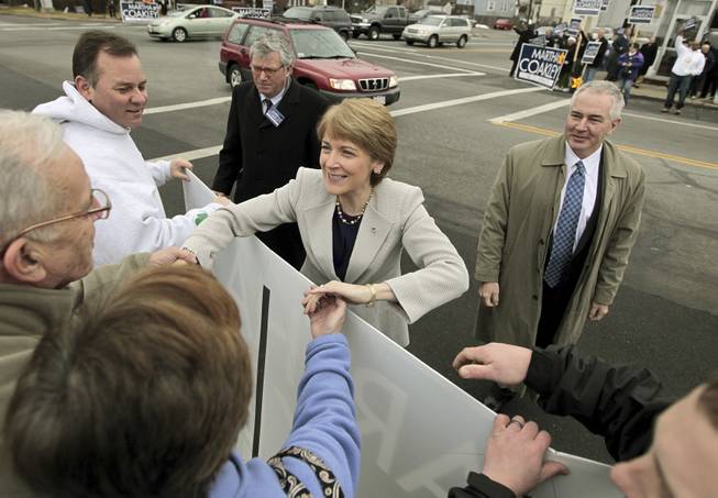 Massachusetts Attorney General Martha Coakley, a Democrat, campaigns with her husband Thomas O'Connor, right, in New Bedford, Mass., Tuesday, Jan. 19, 2010. 
