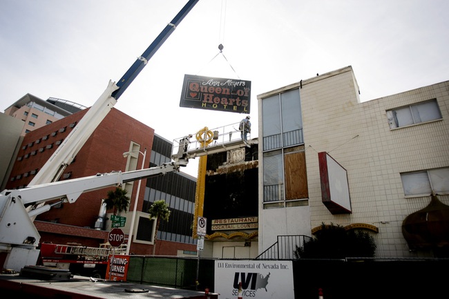 YESCO workers remove the Queen of Hearts Hotel sign after the demolition ceremony for the hotel, part of the ongoing construction to build a new City Hall and office complex in downtown Las Vegas Tuesday, February 2, 2010. The sign will be stored at the Neon Boneyard.