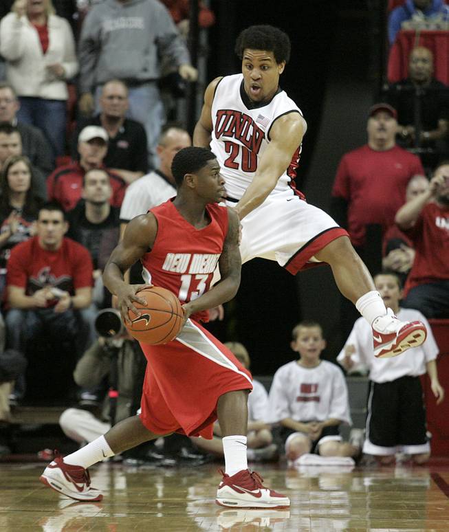 UNLV guard Steve Jones covers New Mexico guard Jamal Fenton during the second half of their Mountain West Conference game Wednesday, Feb. 10, 2010, at the Thomas & Mack Center. The Lobos held off a late Rebel charge to win 76-66.
