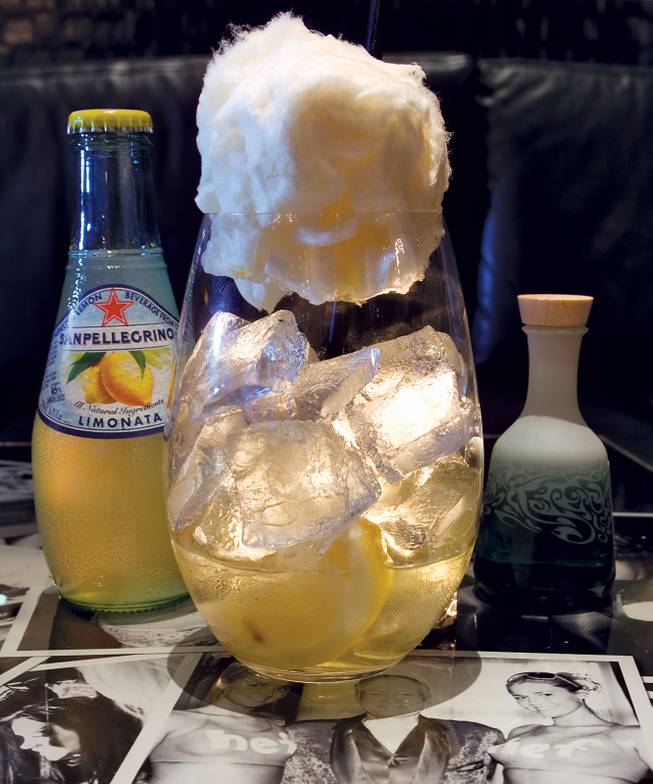 The Bunny Tail, created by N9NE Group mixologist Dave Herlong, was an instant hit when he made it for Hugh Hefner's 83rd birthday in April. The drink starts with limoncello and fresh lemon in a large snifter, then comes the ice, then the piece de resistance: a tuft of cotton candy. From there, it gets interactive, with the guest pouring a mini bottle of Le Tourment Vert absinthe on top, melting the cotton candy, and filling the rest of the glass with San Pellegrino Limonata sparkling soda.