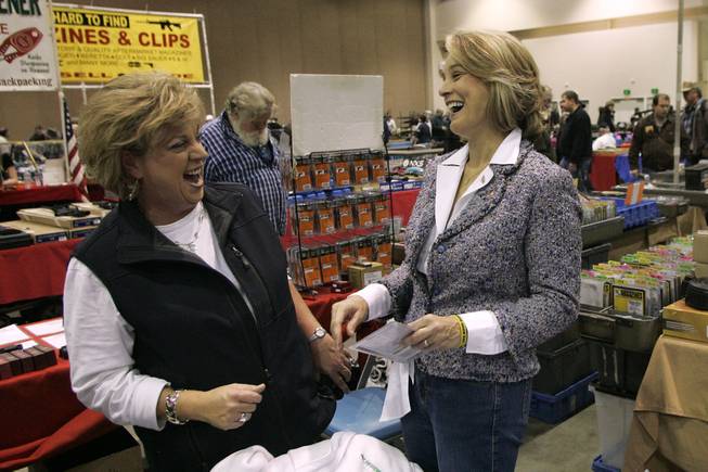 Senate candidate Sue Lowden laughs with Vicki Kawelmacher from the Women's Shooting Academy at a gun show in Reno while on a campaign swing through northern Nevada Sunday, February 21, 2010.