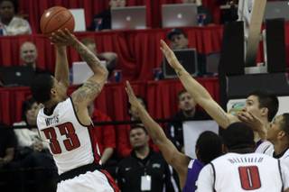 UNLV guard Tre'Von Willis shoots a jumper over the outstretched arms of the TCU defense Wednesday at the Thomas & Mack Center.  The Rebels won the second straight, 78-62.