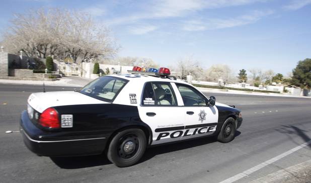 A Metro Police officer drives by property owned by entertainer Wayne Newton in Las Vegas Thursday, Feb. 25, 2010. Moving vans accompanied by official-looking vehicles arrived at the home of Las Vegas entertainer Wayne Newton this morning but left soon after without removing anything. Metro Police said they weren't commenting on the case. 