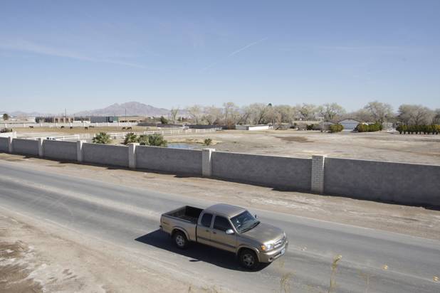 A pick up truck drives by the property owned by entertainer Wayne Newton in Las Vegas Thursday, Feb. 25, 2010. Moving vans accompanied by official-looking vehicles arrived at the home of Las Vegas entertainer Wayne Newton this morning but left soon after without removing anything. Metro Police said they weren't commenting on the case. 