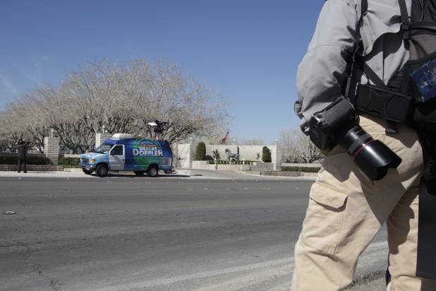 Members of the media wait outside property owned by entertainer Wayne Newton in Las Vegas Thursday, Feb. 25, 2010. Moving vans accompanied by official-looking vehicles arrived at the home of Las Vegas entertainer Wayne Newton this morning but left soon after without removing anything. Metro Police said they weren't commenting on the case. 