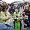 Danica Patrick, center, signs autographs as she walks from the garage to her car hauler at the Las Vegas Motor Speedway on Friday, Feb. 26, 2010.