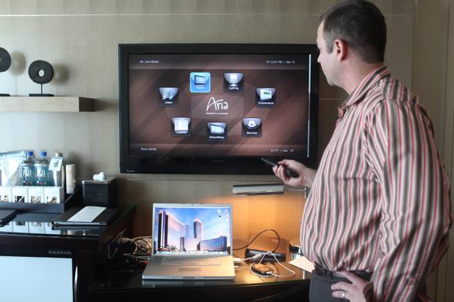 John Bollen, Aria's vice president of information technology, shows how the remote control options display on the TV in a room at Aria on the Las Vegas Strip on Friday, March 12, 2010. 