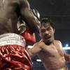 Manny Pacquiao, right, of the Philippines, delivers a body shot to Joshua Clottey, from Ghana, during their WBO boxing welterweight title fight in Cowboys Stadium in Arlington, Texas, on Saturday, March 13, 2010.