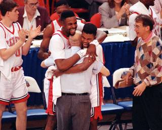 UNLV players Moses Scurry, left, and Anderson Hunt hug coach Jerry Tarkanian after their 103-73 victory over Duke in the NCAA Final Four Championship game, April 2, 1990, in Denver.