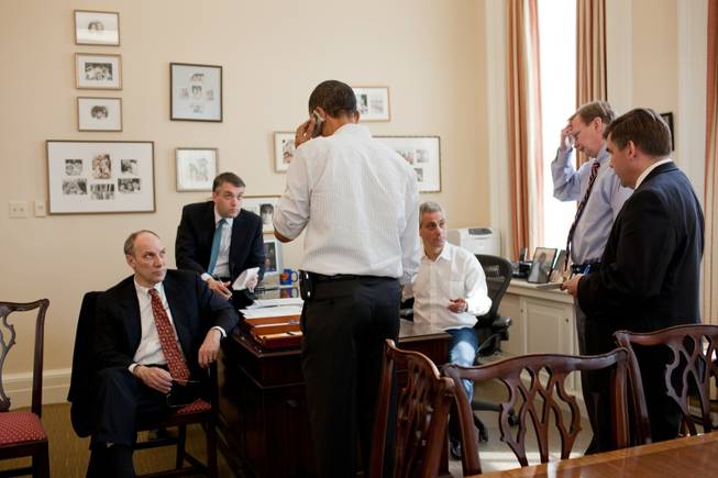 This photo provided by the White House taken Sunday, March 21, 2010, shows President Barack Obama talking on the phone with a member of Congress in the Chief of Staff's office at the White House.  Aides, from left are, Phil Schiliro, Sean Sweeney, Rahm Emanuel, Jim Messina, and Dan Turton.