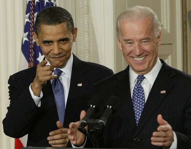 President Barack Obama and Vice President Joe Biden react to cheers as they arrive in the East Room of the White House in Washington,Tuesday, March 23, 2010, for the signing ceremony for the health care bill.