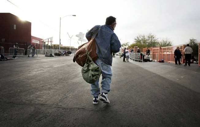 Jamshid Afshar walks down Foremaster Lane with all his belongings. Foremaster is Afshar's home, and ground zero for the Las Vegas homeless population.