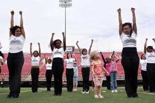 Jewelia Eck, 3, front right, tries to follow hopeful Locomotives dance team members during a short dance session with Locos fans at Sam Boyd Stadium on Sunday, April 11, 2010.  The dance team for 2010 has auditions coming up this summer. 