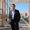 John Stewart, a principal of Juliet Cos., is shown on the pad of a building under construction in front of the Green Valley Crossing shopping center in Henderson.