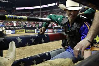 Renato Nunes, of Brazil, prepares to take his first ride on the final day of the PBR World Finals at the Thomas & Mack Center in Las Vegas on Sunday April 18, 2010.