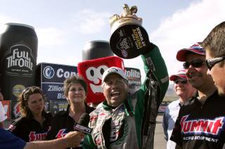 John Force celebrates his victory in the funny car division during the NHRA SummitRacing Nationals Sunday, April 18, 2010 at the Las Vegas Motor Speedway.