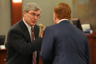 Attorney Mark Tully, representing drug companies, speaks with plaintiff's attorney Robert Eglet, right, during a break in the endoscopy trial on Monday, April 19, at the Regional Justice Center.