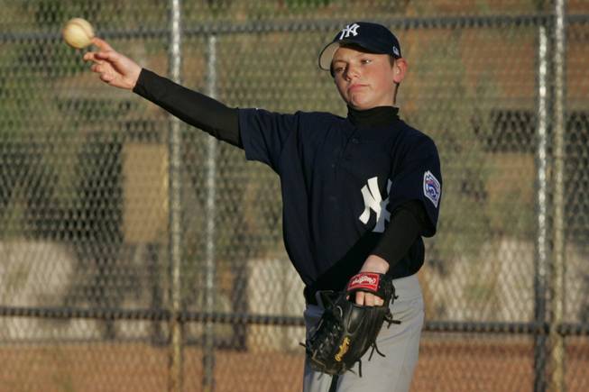 Justin Rasavage warms up during a Peccole Little League game Wednesday, April 21, 2010.